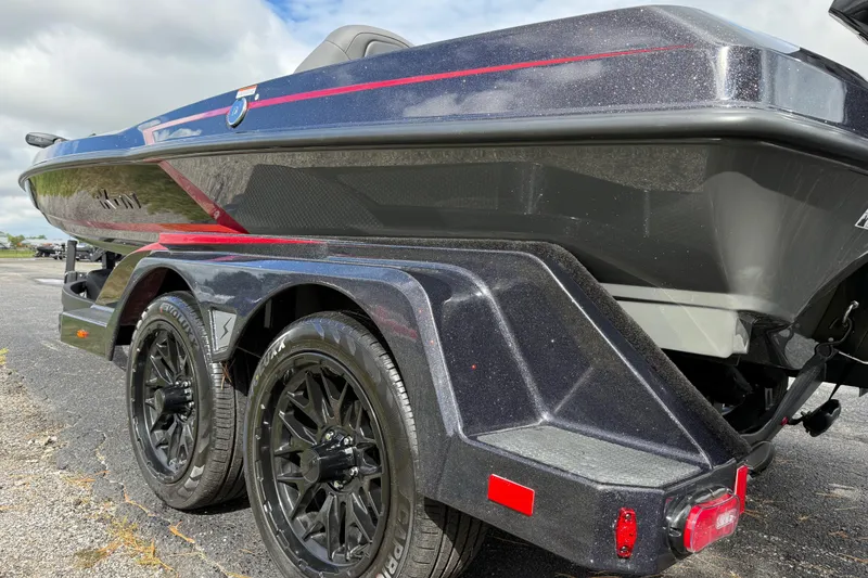 Slide: The Image of 2026 iKon LXE21 boat on trailer, featuring sleek design and black wheels. - 19