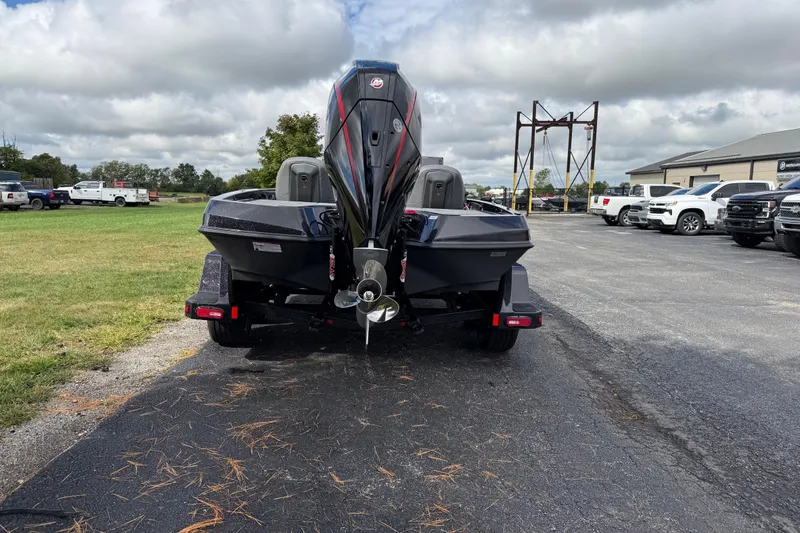 Slide: The Image of 2026 iKon LXE21 boat on trailer, parked outdoors with cloudy sky background. - 3