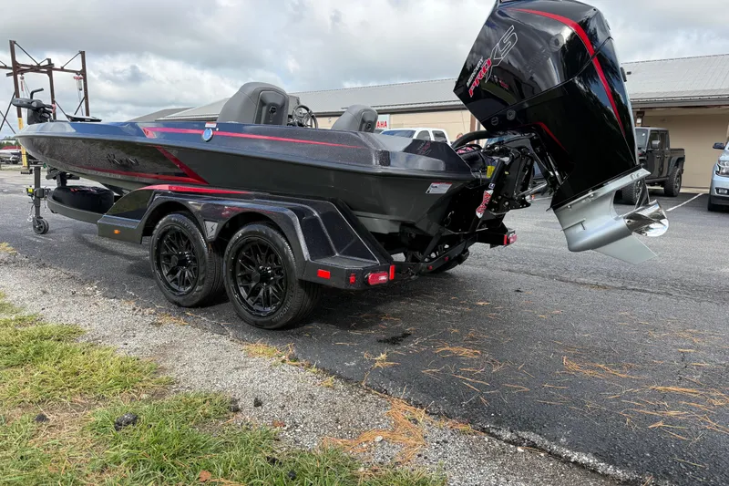 Slide: The Image of 2026 iKon LXE21 boat with powerful outboard motor on a trailer, parked outdoors. - 4