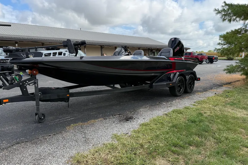Slide: The Image of 2026 iKon LXE21 boat on trailer, parked outdoors near a building. - 6