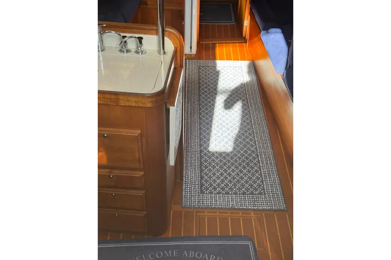 Slide: The Image of Interior of 2005 Sabre 386 yacht with wooden flooring and patterned rug. - 12