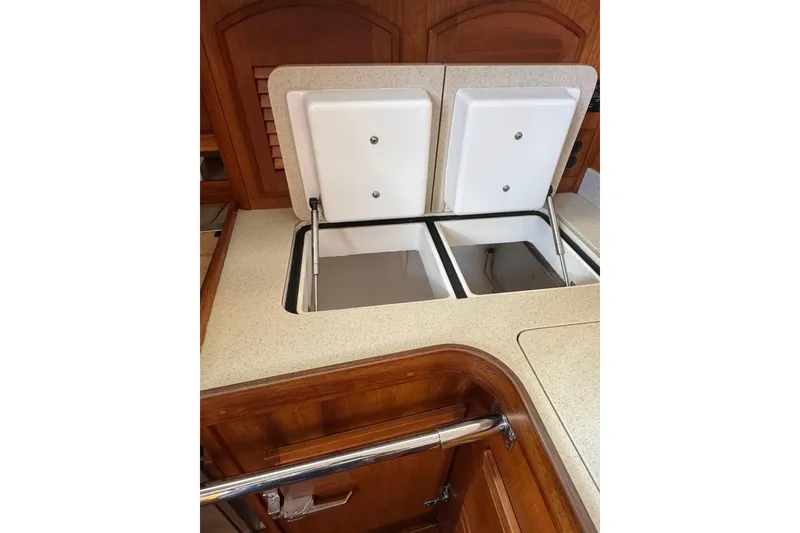 Slide: The Image of 2005 Sabre 386 yacht kitchen with dual compartment storage and wooden cabinetry. - 15