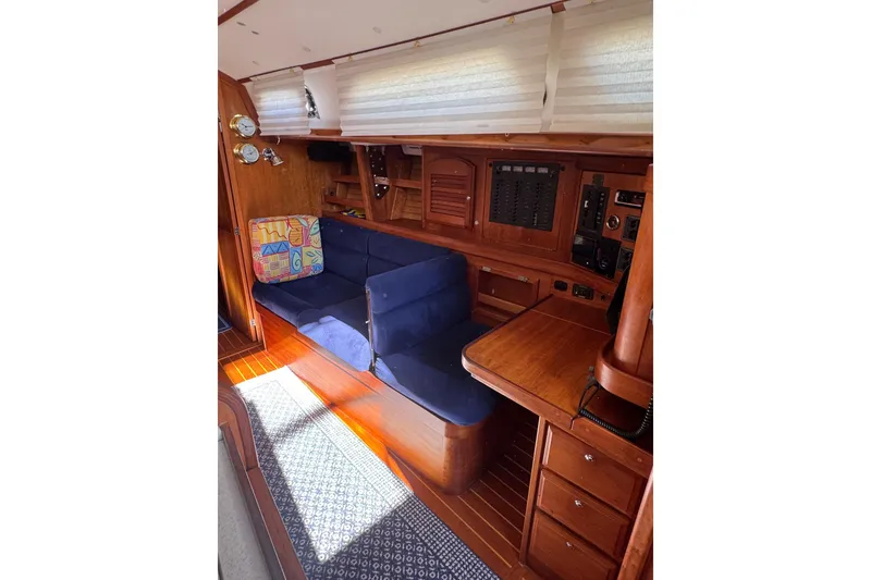 Slide: The Image of Interior of 2005 Sabre 386 yacht with blue seating and wooden cabinetry. - 17