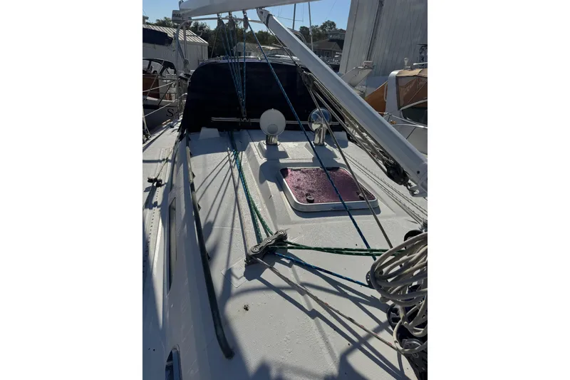 Slide: The Image of 2005 Sabre 386 sailboat deck with rigging and hatch, docked in marina. - 2