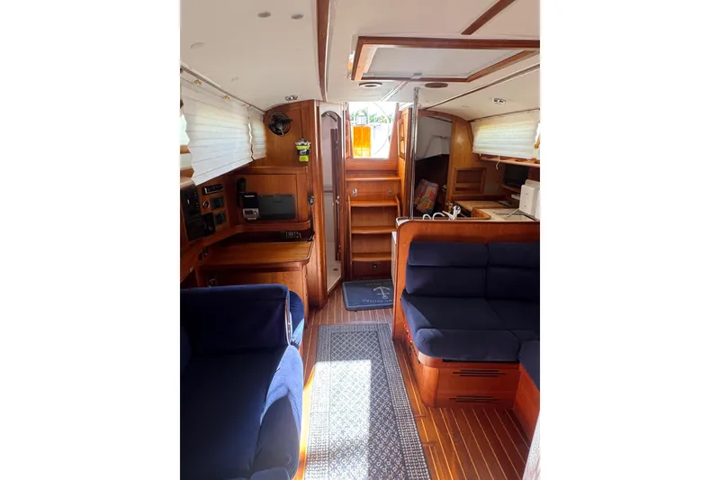 Slide: The Image of Interior of 2005 Sabre 386 sailboat with wooden furnishings and blue seating. - 20