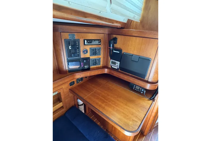 Slide: The Image of Navigation station of 2005 Sabre 386 sailboat with control panels and communication equipment. - 21