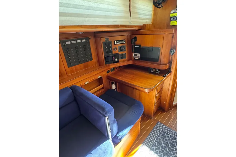 Slide: The Image of 2005 Sabre 386 yacht interior with navigation station and blue seating. - 22