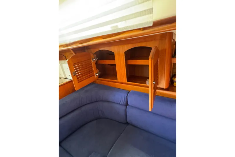 Slide: The Image of Interior of 2005 Sabre 386 yacht with wooden cabinets and blue seating. - 23