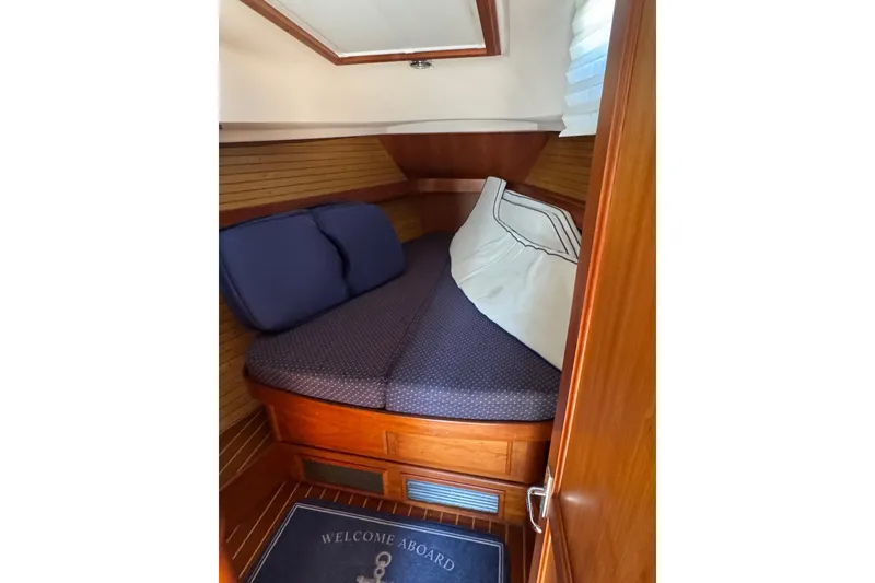 Slide: The Image of Cozy cabin interior of 2005 Sabre 386 yacht with wooden finish and comfortable bedding. - 26