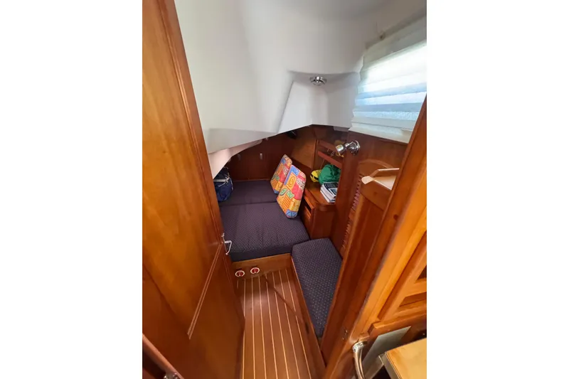Slide: The Image of Cozy cabin interior of 2005 Sabre 386 sailboat with colorful cushions and wooden finish. - 27