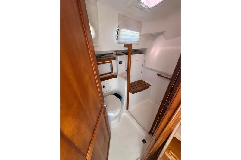 Slide: The Image of 2005 Sabre 386 yacht bathroom with wooden accents and compact design. - 28
