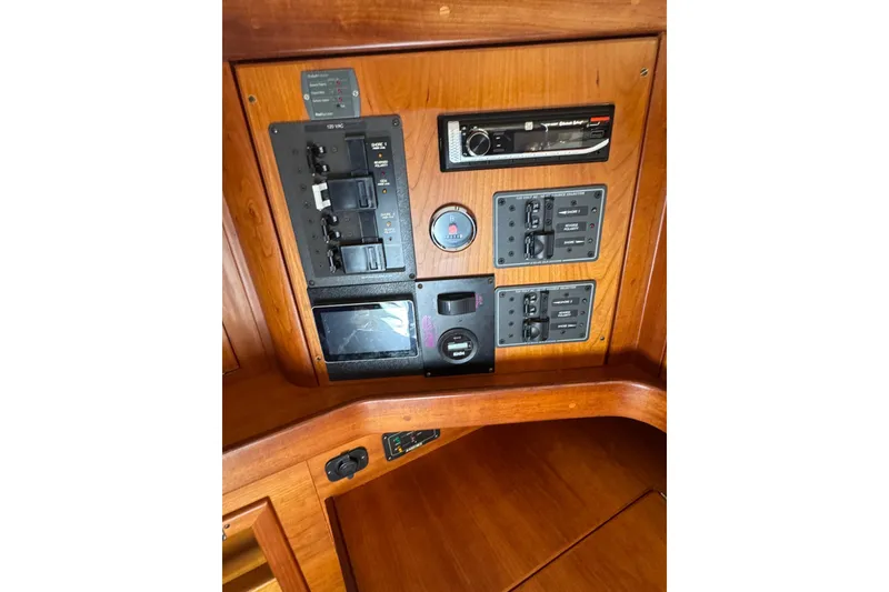 Slide: The Image of Control panel of a 2005 Sabre 386 yacht with various switches and gauges. - 35