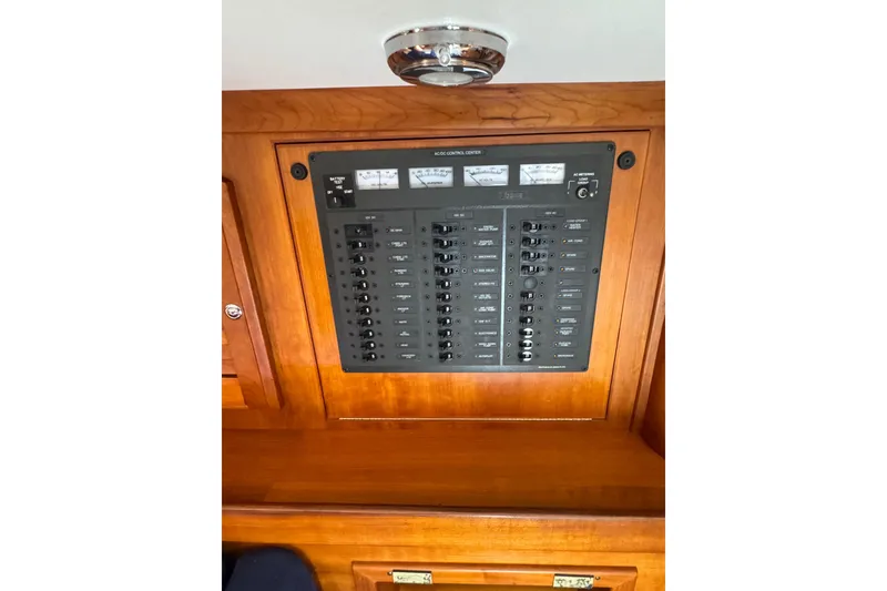 Slide: The Image of Electrical control panel on a 2005 Sabre 386 yacht, featuring multiple switches and gauges. - 36