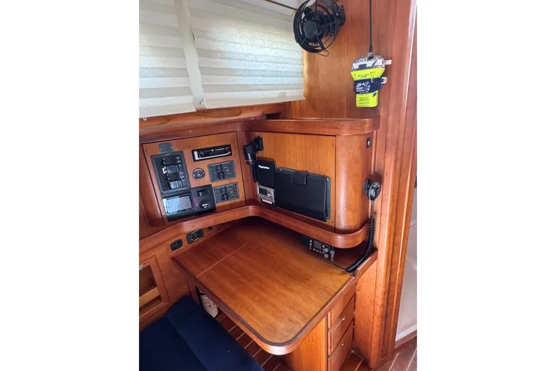 Slide: The Image of 2005 Sabre 386 yacht navigation station with wooden desk and control panels. - 37