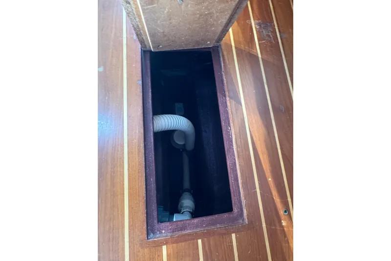 Slide: The Image of Wooden boat floor compartment with visible plumbing, Sabre 386, 2005 model. - 38