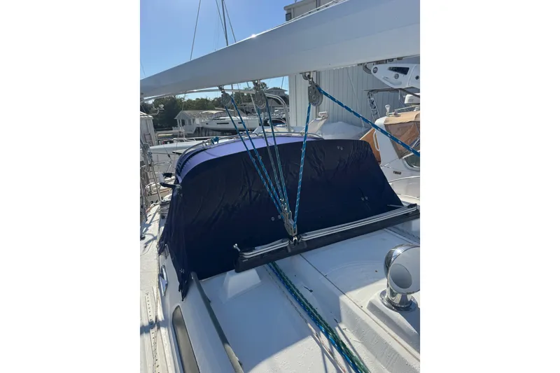 Slide: The Image of 2005 Sabre 386 sailboat deck with blue canopy and rigging. - 5