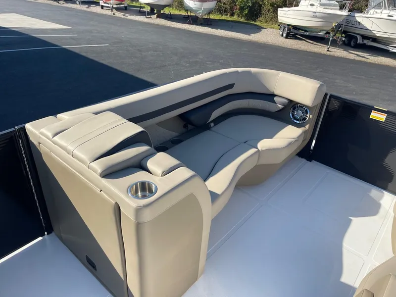 Slide: The Image of 2023 Hurricane FunDeck 2360 SBC boat interior with beige seating and cup holders. - 12