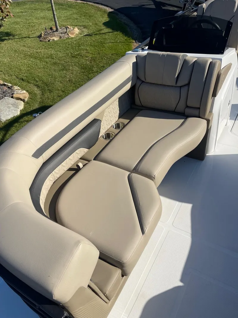 Slide: The Image of 2023 Hurricane FunDeck 2360 SBC boat with beige seating and sleek design. - 14