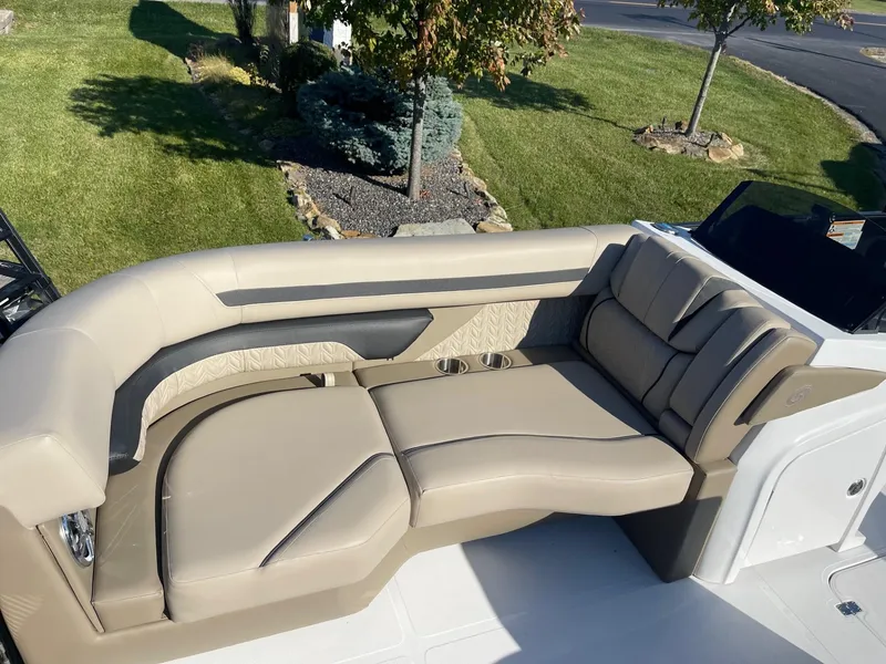 Slide: The Image of 2023 Hurricane FunDeck 2360 SBC boat with beige seating and cup holders. - 16