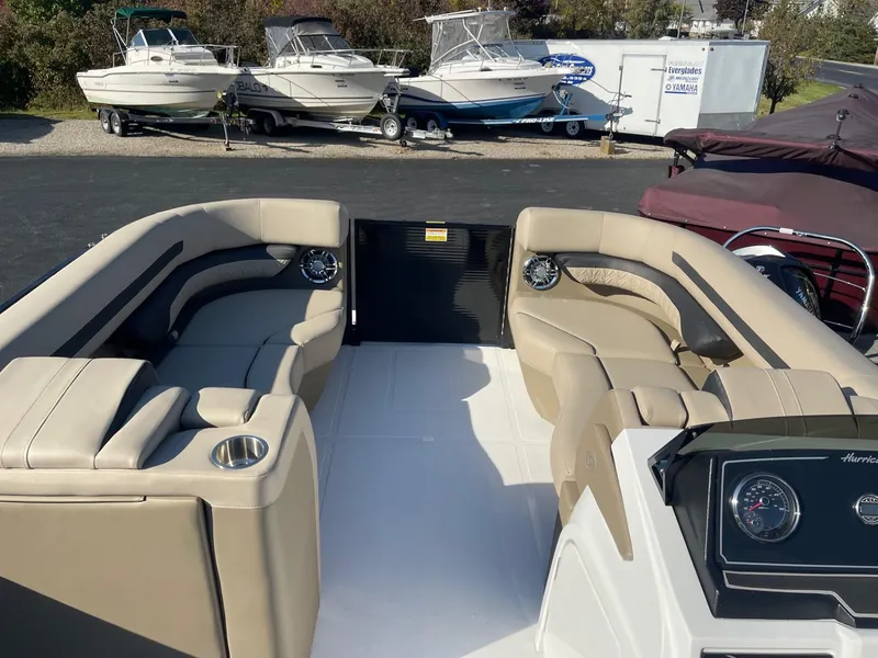 Slide: The Image of 2023 Hurricane FunDeck 2360 SBC boat interior with beige seating and dashboard. - 18