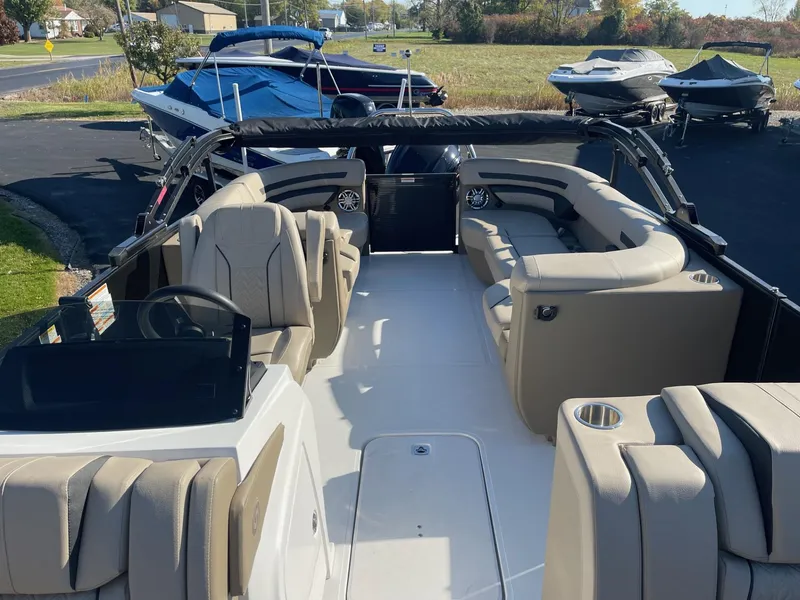 Slide: The Image of 2023 Hurricane FunDeck 2360 SBC boat interior with beige seating and spacious layout. - 19