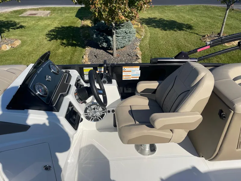 Slide: The Image of 2023 Hurricane FunDeck 2360 SBC boat interior with steering wheel and captain's chair. - 20