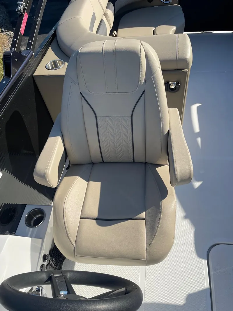 Slide: The Image of 2023 Hurricane FunDeck 2360 SBC boat interior with beige captain's chair. - 21