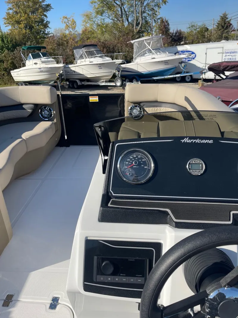 Slide: The Image of 2023 Hurricane FunDeck 2360 SBC boat interior with steering wheel and dashboard. - 23