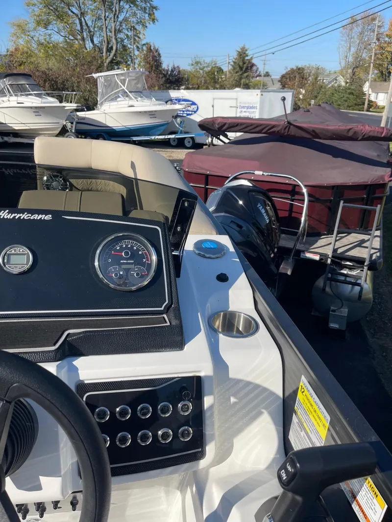 Slide: The Image of 2023 Hurricane FunDeck 2360 SBC boat dashboard with gauges and controls. - 24