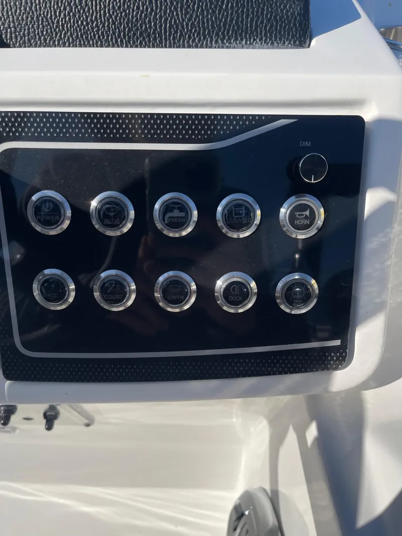 Slide: The Image of Control panel of 2023 Hurricane FunDeck 2360 SBC boat with multiple buttons. - 28