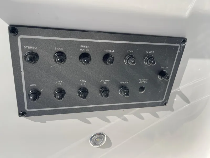 Slide: The Image of Control panel of 2023 Hurricane FunDeck 2360 SBC boat with various switches. - 31