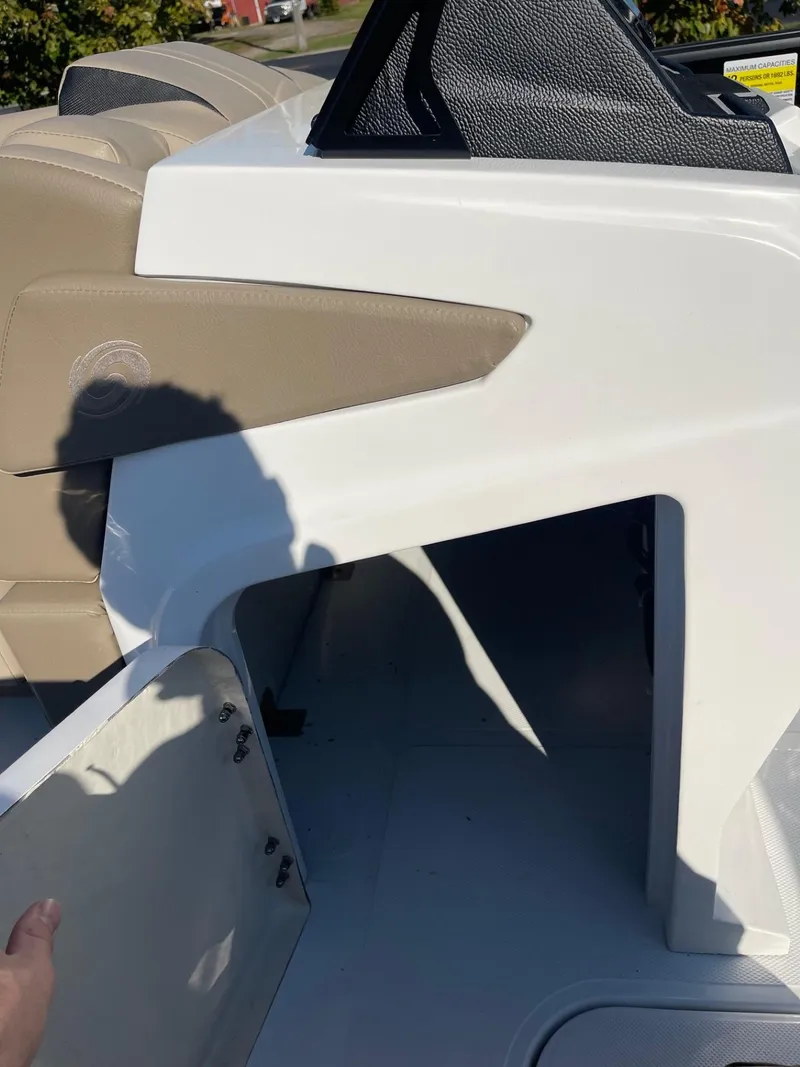 Slide: The Image of 2023 Hurricane FunDeck 2360 SBC boat interior with open storage compartment. - 32