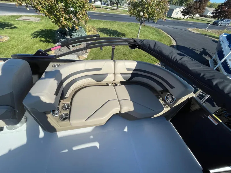 Slide: The Image of 2023 Hurricane FunDeck 2360 SBC boat with beige seating and cup holders. - 36