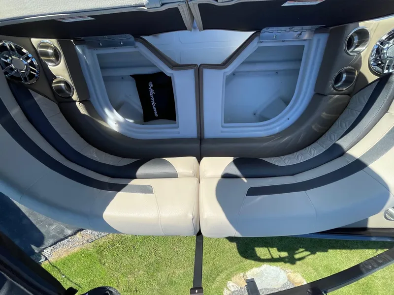 Slide: The Image of 2023 Hurricane FunDeck 2360 SBC interior seating with storage compartments and cup holders. - 37