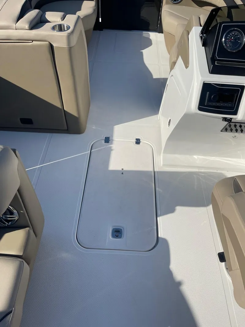 Slide: The Image of Interior of 2023 Hurricane FunDeck 2360 SBC boat with beige seating and control panel. - 38