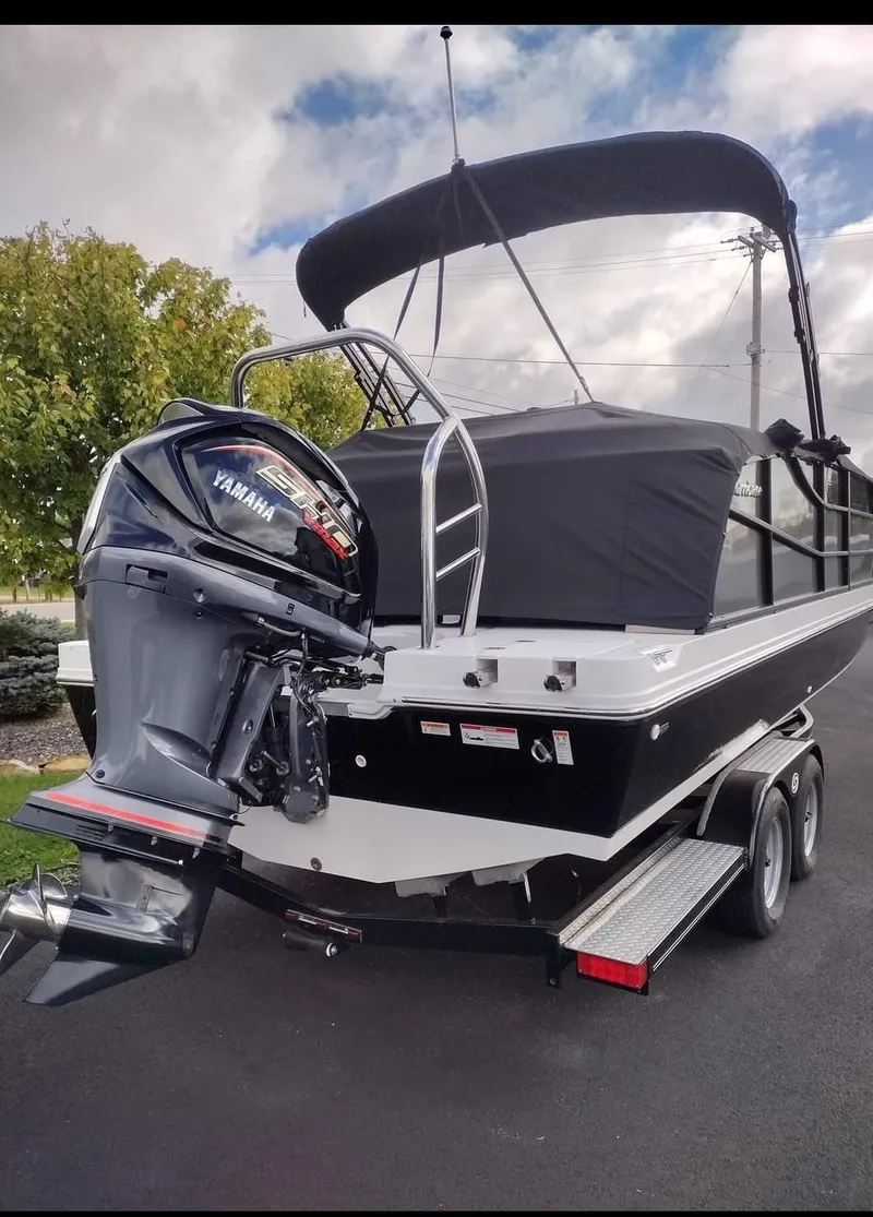 Slide: The Image of 2023 Hurricane FunDeck 2360 SBC boat with Yamaha outboard motor on trailer. - 4