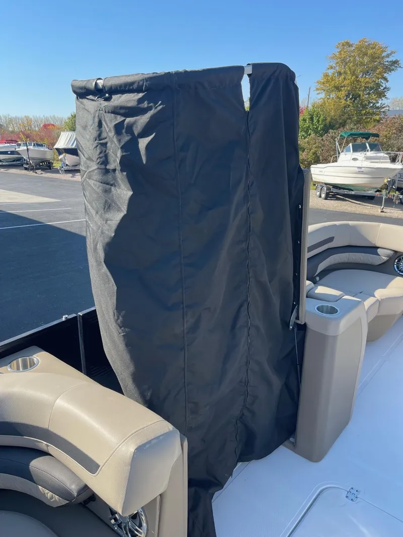 Slide: The Image of 2023 Hurricane FunDeck 2360 SBC boat with black privacy curtain on deck. - 40