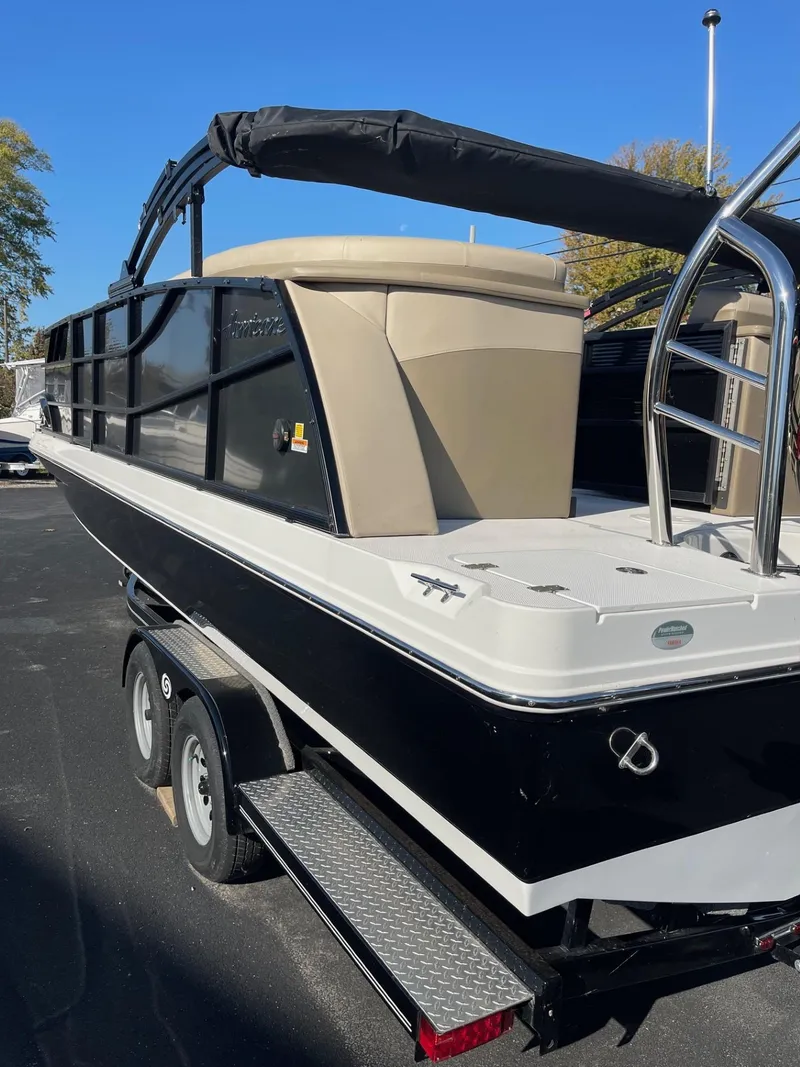 Slide: The Image of 2023 Hurricane FunDeck 2360 SBC boat on trailer, black and beige design. - 44
