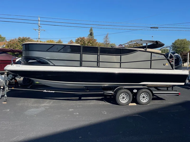 Slide: The Image of 2023 Hurricane FunDeck 2360 SBC boat on trailer, parked outdoors. - 5