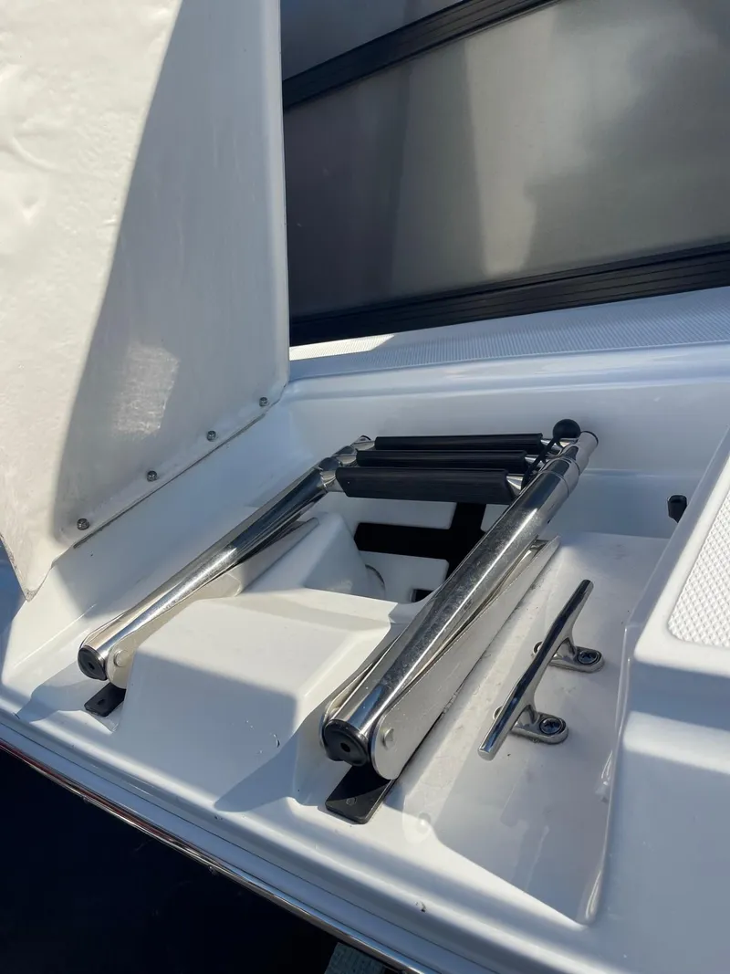Slide: The Image of 2023 Hurricane FunDeck 2360 SBC boat ladder compartment, open and ready for use. - 7