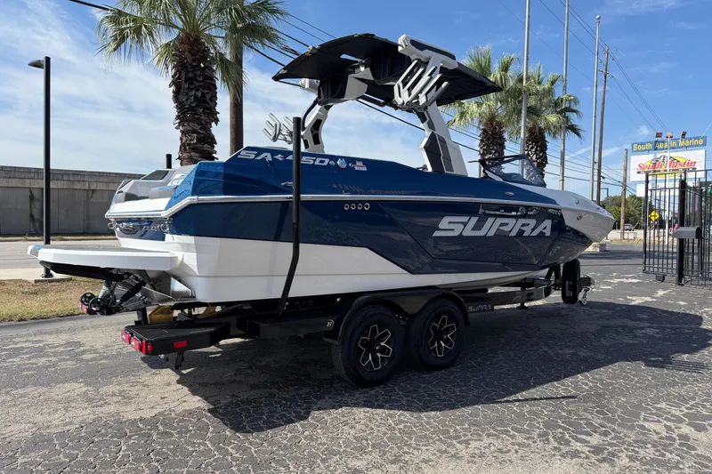 Slide: The Image of 2026 Supra SA 450 boat on trailer, parked outdoors near palm trees. - 12