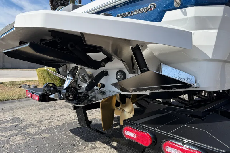 Slide: The Image of 2026 Supra SA 450 boat rear view with propeller and SwellSurf system. - 13