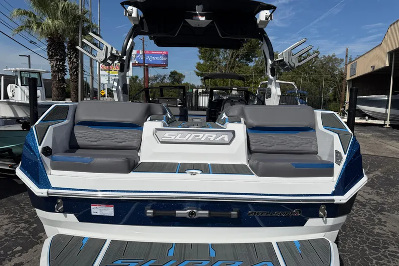 Slide: The Image of 2026 Supra SA 450 boat with sleek design, gray and blue seating, and advanced features. - 18