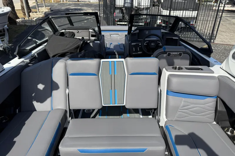 Slide: The Image of 2026 Supra SA 450 boat interior with gray and blue seating, modern dashboard, and open cockpit. - 27