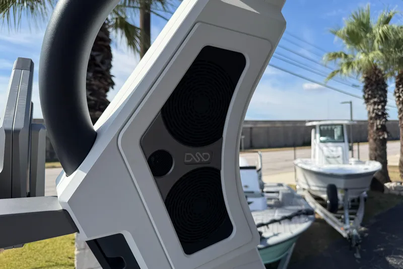 Slide: The Image of Close-up of 2026 Supra SA 450 boat speaker system with palm trees in the background. - 29
