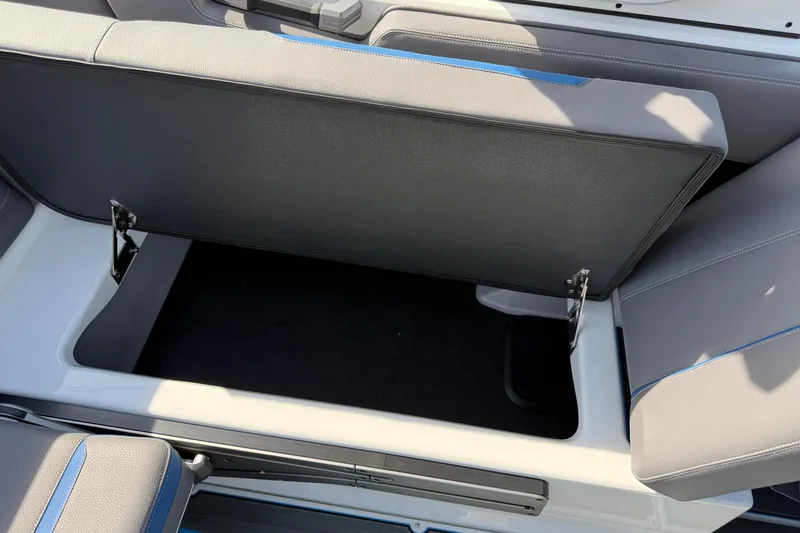 Slide: The Image of 2026 Supra SA 450 boat seat storage compartment, open with visible hinges and upholstery. - 35