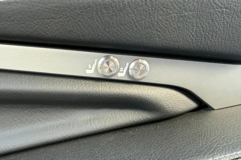 Slide: The Image of 2026 Supra SA 450 seat adjustment buttons on black leather interior. - 46