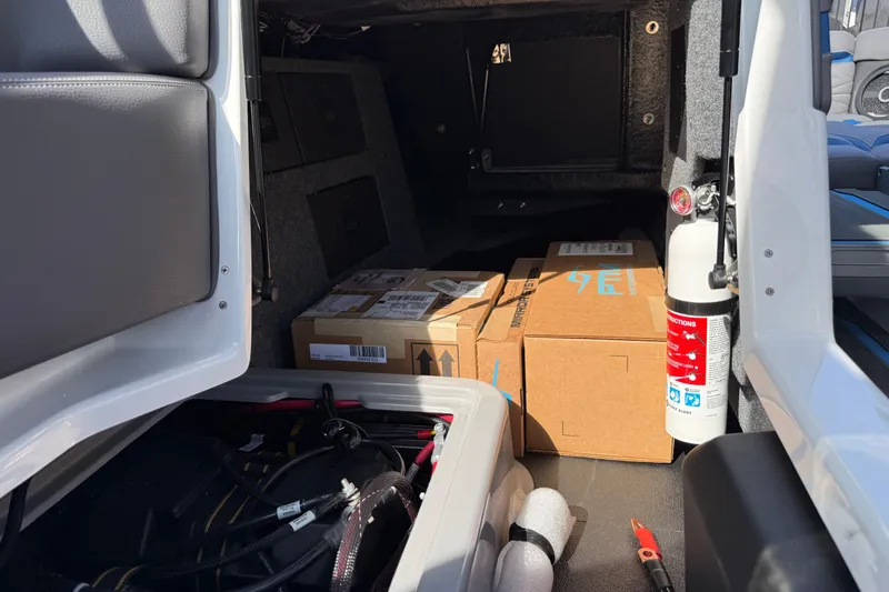 Slide: The Image of Interior storage of 2026 Supra SA 450 boat with boxes and fire extinguisher. - 47