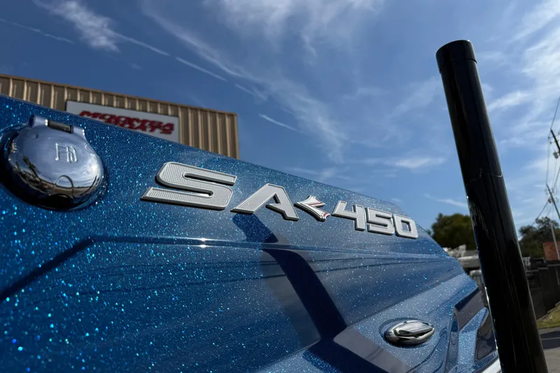 Slide: The Image of 2026 Supra SA 450 boat with metallic blue finish under clear sky. - 5