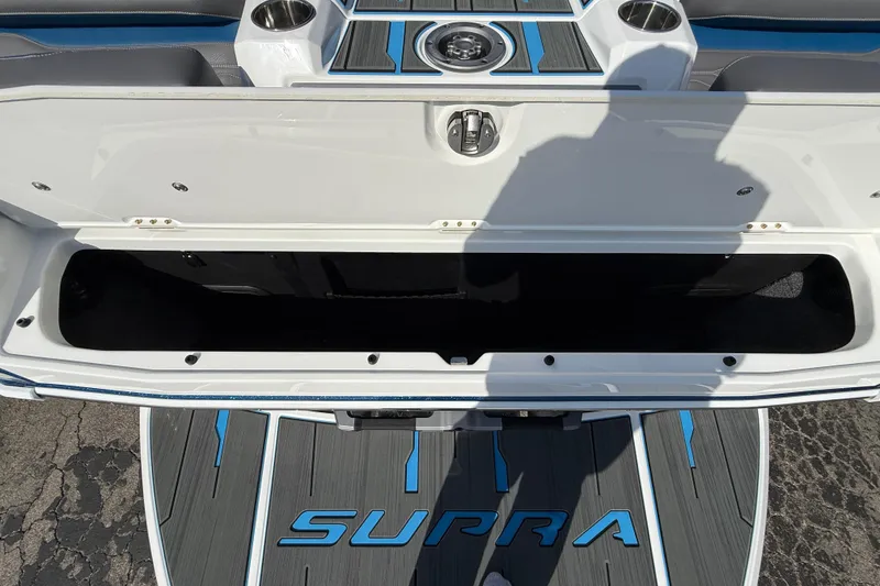 Slide: The Image of 2026 Supra SA 450 boat storage compartment with open lid, showcasing interior space. - 55